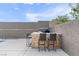 Outdoor kitchen and seating area with stone accents is perfect for outdoor cooking and dining at 6421 Winecup St, Las Vegas, NV 89149