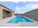 Relaxing backyard pool and patio area, complete with mounted tv and outdoor dining at 6421 Winecup St, Las Vegas, NV 89149