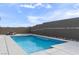 Backyard with inviting pool, spa, and custom fire pit creating a beautiful outdoor living space at 6421 Winecup St, Las Vegas, NV 89149