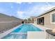 Inviting backyard pool and spa with custom landscape design and stone accent wall enhance outdoor living at 6421 Winecup St, Las Vegas, NV 89149