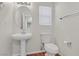 Well-lit half bathroom with a pedestal sink, modern fixtures, and neutral color scheme at 6559 Tumbleweed Ridge Ln # 103, Henderson, NV 89011