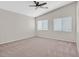 Spacious bedroom featuring large windows, ceiling fan, and comfortable carpet at 6559 Tumbleweed Ridge Ln # 103, Henderson, NV 89011