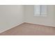 Neutral bedroom with cozy carpet, window, and ample natural light at 6559 Tumbleweed Ridge Ln # 103, Henderson, NV 89011
