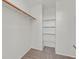 Walk-in closet with shelves and hanging rod, providing ample storage space at 6559 Tumbleweed Ridge Ln # 103, Henderson, NV 89011