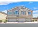 Inviting townhome featuring a three-car garage, charming balcony, and traditional architecture at 6559 Tumbleweed Ridge Ln # 103, Henderson, NV 89011