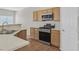 Well-equipped kitchen with stainless steel appliances and hardwood flooring, offering functional style at 6559 Tumbleweed Ridge Ln # 103, Henderson, NV 89011