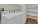 Bright laundry room featuring a white washer and dryer set, and ample shelving for storage at 6559 Tumbleweed Ridge Ln # 103, Henderson, NV 89011