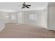 Spacious living room with carpet flooring, neutral paint, bright windows, and a ceiling fan at 6559 Tumbleweed Ridge Ln # 103, Henderson, NV 89011
