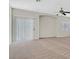 Large living room with carpet flooring, light walls, ceiling fan, and sliding glass door at 6559 Tumbleweed Ridge Ln # 103, Henderson, NV 89011