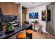 Wet bar with stainless steel refrigerator, built in shelves, and leather stools at 658 Agate Bridge St, Las Vegas, NV 89138