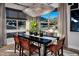 Dining room features a modern chandelier, decorative rug and large windows with mountain views at 658 Agate Bridge St, Las Vegas, NV 89138