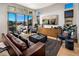 Bright living room with hardwood floors, large windows, comfortable seating, and modern decor at 658 Agate Bridge St, Las Vegas, NV 89138