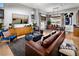 Open-concept living room featuring modern decor, hardwood floors, and seamless flow into the dining area at 658 Agate Bridge St, Las Vegas, NV 89138