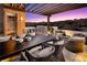 Outdoor dining and lounge area on a rooftop patio with pergola and mountain views at 658 Agate Bridge St, Las Vegas, NV 89138
