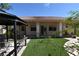Lush backyard with a gazebo, synthetic grass, and mature landscaping, perfect for relaxing or entertaining outdoors at 7250 Birkland Ct, Las Vegas, NV 89117