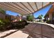 Lush backyard featuring a rock pond, mature trees, and stone tile provides a serene outdoor space at 7250 Birkland Ct, Las Vegas, NV 89117
