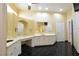 A well-lit bathroom features dual vanities with marble countertops and white cabinetry at 7250 Birkland Ct, Las Vegas, NV 89117