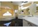 Luxurious bathroom featuring a soaking tub, dual vanities, and sleek tile flooring at 7250 Birkland Ct, Las Vegas, NV 89117