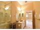 Bright bathroom featuring a glass shower, marble countertop, and decorative fixtures at 7250 Birkland Ct, Las Vegas, NV 89117