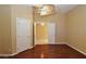 Bedroom with hardwood floors and three doorways at 7250 Birkland Ct, Las Vegas, NV 89117