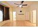 This bedroom features wood floors, ceiling fan, and a door to the Primary bathroom at 7250 Birkland Ct, Las Vegas, NV 89117