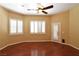 Bedroom boasts hardwood floors, ample light, and access to the outside area at 7250 Birkland Ct, Las Vegas, NV 89117