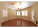 Spacious bedroom with hardwood floors, shuttered windows, and a ceiling fan at 7250 Birkland Ct, Las Vegas, NV 89117