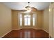 Bedroom with hardwood floors, shutters, and large windows at 7250 Birkland Ct, Las Vegas, NV 89117