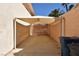 Well-lit carport offering shaded parking space, adjacent to a clean yard and side of house at 7250 Birkland Ct, Las Vegas, NV 89117