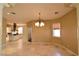 Open dining room featuring tile flooring, designer lighting, and an open floorplan to the kitchen at 7250 Birkland Ct, Las Vegas, NV 89117