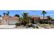 Charming single-story home featuring a tile roof, desert landscaping, and a well-manicured yard at 7250 Birkland Ct, Las Vegas, NV 89117
