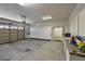Spacious garage featuring ample storage cabinets, overhead lighting, and an automatic door at 7250 Birkland Ct, Las Vegas, NV 89117