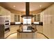 Beautiful kitchen featuring a granite island cooktop, stainless appliances, and plenty of storage space at 7250 Birkland Ct, Las Vegas, NV 89117