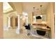 This home features a kitchen bar with seating, a beverage cooler, and marble countertops at 7250 Birkland Ct, Las Vegas, NV 89117