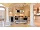 This home features a kitchen bar with seating, a beverage cooler, and marble countertops at 7250 Birkland Ct, Las Vegas, NV 89117