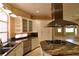 Well-equipped kitchen with stainless steel appliances, double sinks, granite countertops, island, and ample cabinet space at 7250 Birkland Ct, Las Vegas, NV 89117