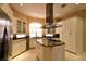 Spacious kitchen with island cooktop, stainless appliances, granite counters, and generous cabinet storage at 7250 Birkland Ct, Las Vegas, NV 89117