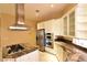 Modern kitchen featuring stainless steel appliances, granite countertops, and a functional center island with gas cooktop at 7250 Birkland Ct, Las Vegas, NV 89117