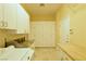 Functional laundry room with ample cabinet space, granite countertops, and modern appliances at 7250 Birkland Ct, Las Vegas, NV 89117