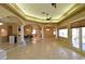 Bright living area featuring tile floors, archways, and a view of the outdoor patio at 7250 Birkland Ct, Las Vegas, NV 89117