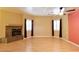 Bright living room with modern fireplace, neutral walls, wood floors, and large windows with wood-tone curtains at 7250 Birkland Ct, Las Vegas, NV 89117