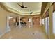 Expansive living space with tile flooring, large windows, and a connected bar area at 7250 Birkland Ct, Las Vegas, NV 89117
