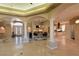 Spacious living area featuring tile flooring, elegant columns, open floorplan and granite countertops at 7250 Birkland Ct, Las Vegas, NV 89117