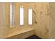 Tiled walk-in shower with built-in bench and glass block windows at 7250 Birkland Ct, Las Vegas, NV 89117