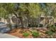Home exterior with mature landscaping, a gated courtyard, and a multi-car garage at 7716 Bauble Ave, Las Vegas, NV 89128