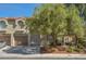 Charming townhome exterior with well-maintained landscaping and attached two-car garage at 7716 Bauble Ave, Las Vegas, NV 89128