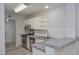 Charming kitchen with granite countertops, white cabinetry, stainless steel appliances, and an open layout at 7716 Bauble Ave, Las Vegas, NV 89128