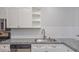 Kitchen featuring granite countertops, stainless steel appliances, white cabinets, and subway tile backsplash at 7716 Bauble Ave, Las Vegas, NV 89128