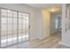 Bright living room with sliding glass doors to the patio and stylish laminate flooring at 7716 Bauble Ave, Las Vegas, NV 89128
