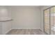 Bright living area featuring sleek flooring, neutral walls, and access to the backyard at 7716 Bauble Ave, Las Vegas, NV 89128